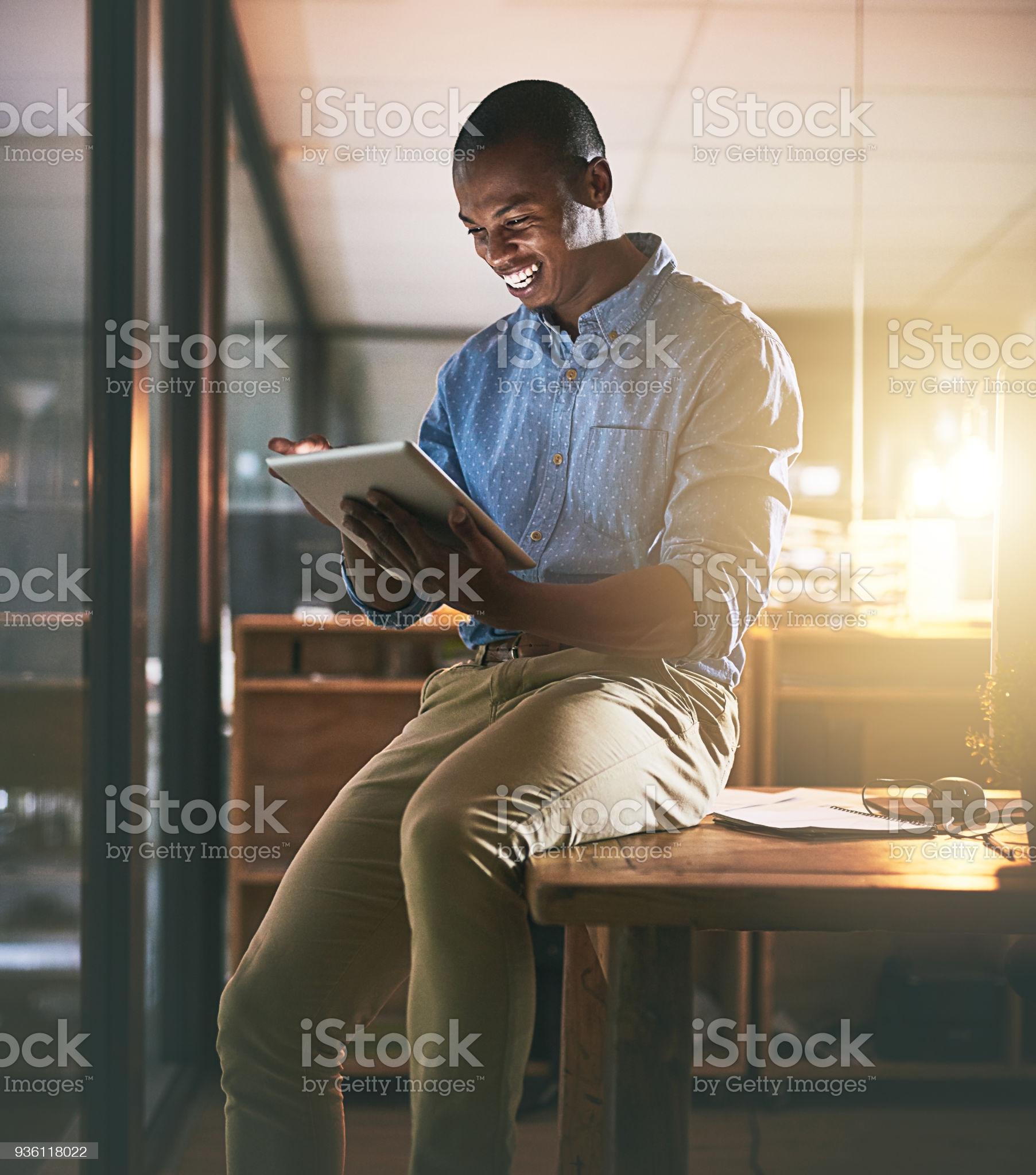 Shot of a young businessman using a digital tablet during a late night in a modern office